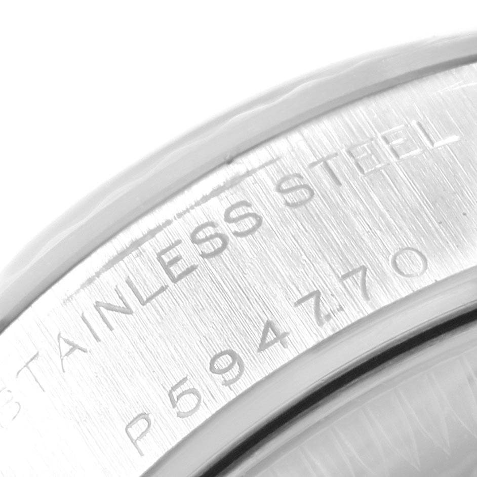 The image shows a close-up angle of the caseback and edge of a Rolex Datejust 79174 Women's Stainless Steel Pink Dial 79174 Women's Stainless Steel Pink Dial model, highlighting the stainless steel engraving and serial number.