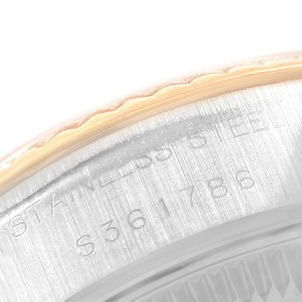 This close-up image shows the engraved serial number on the stainless steel case back edge of a Rolex Datejust 69173 Women
s Stainless Steel White Dial 69173 Women
s Stainless Steel White Dial watch.