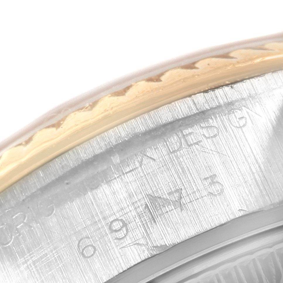 This close-up image shows the edge of the bezel and engraved details on the casing of a Datejust model by Rolex.