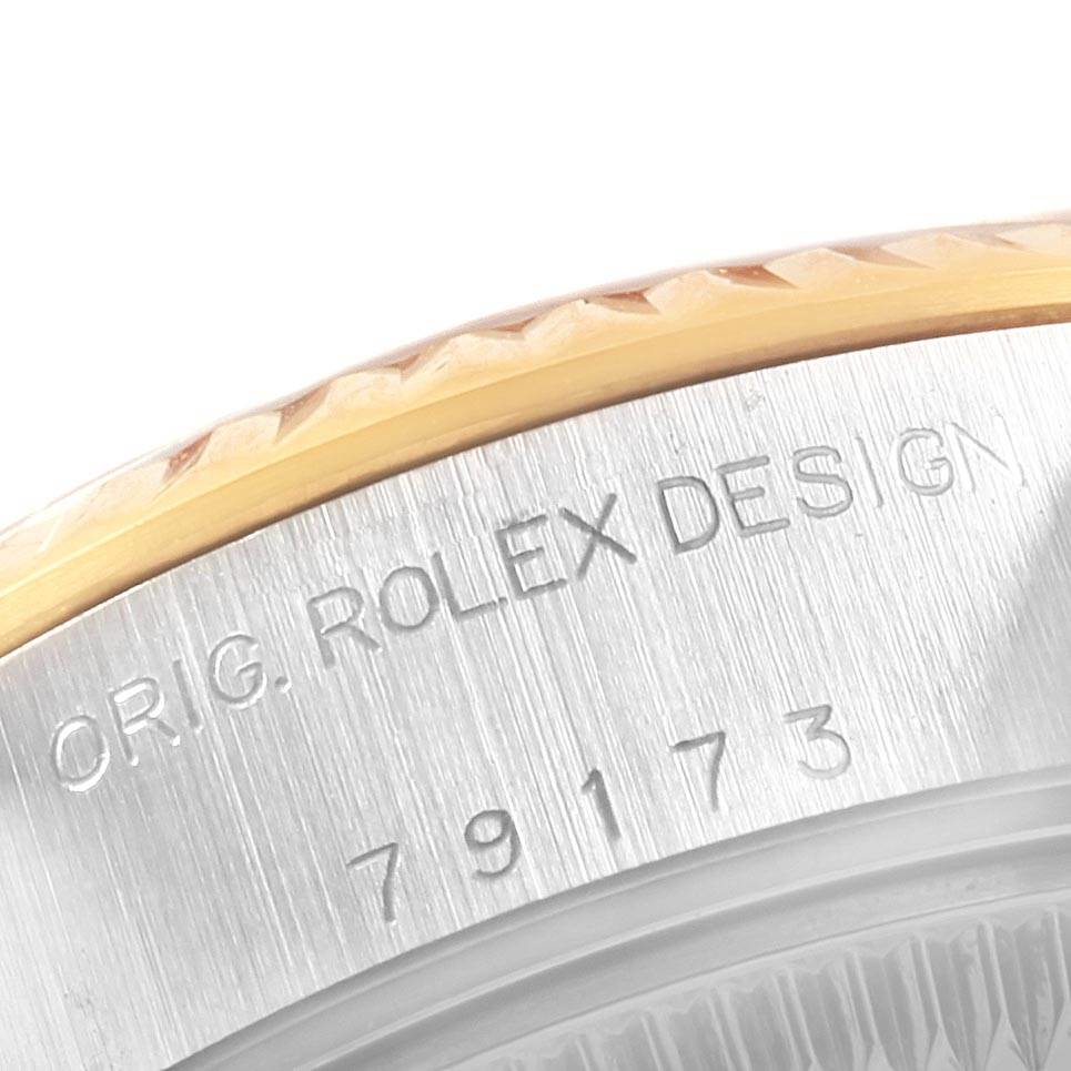 A close-up angle showing the serial number and "ROLEX DESIGN" engraving on the case side of a Rolex Datejust 79173 Women's Steel and Gold (two tone) White Dial 79173 Women's Steel and Gold (two tone) White Dial watch.