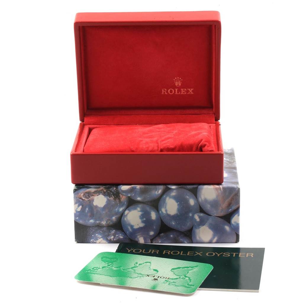 This image shows the accessories of a Rolex Datejust 69174 Women
s Stainless Steel Pink Dial 69174 Women
s Stainless Steel Pink Dial, including a red watch box, pillow, and warranty card.