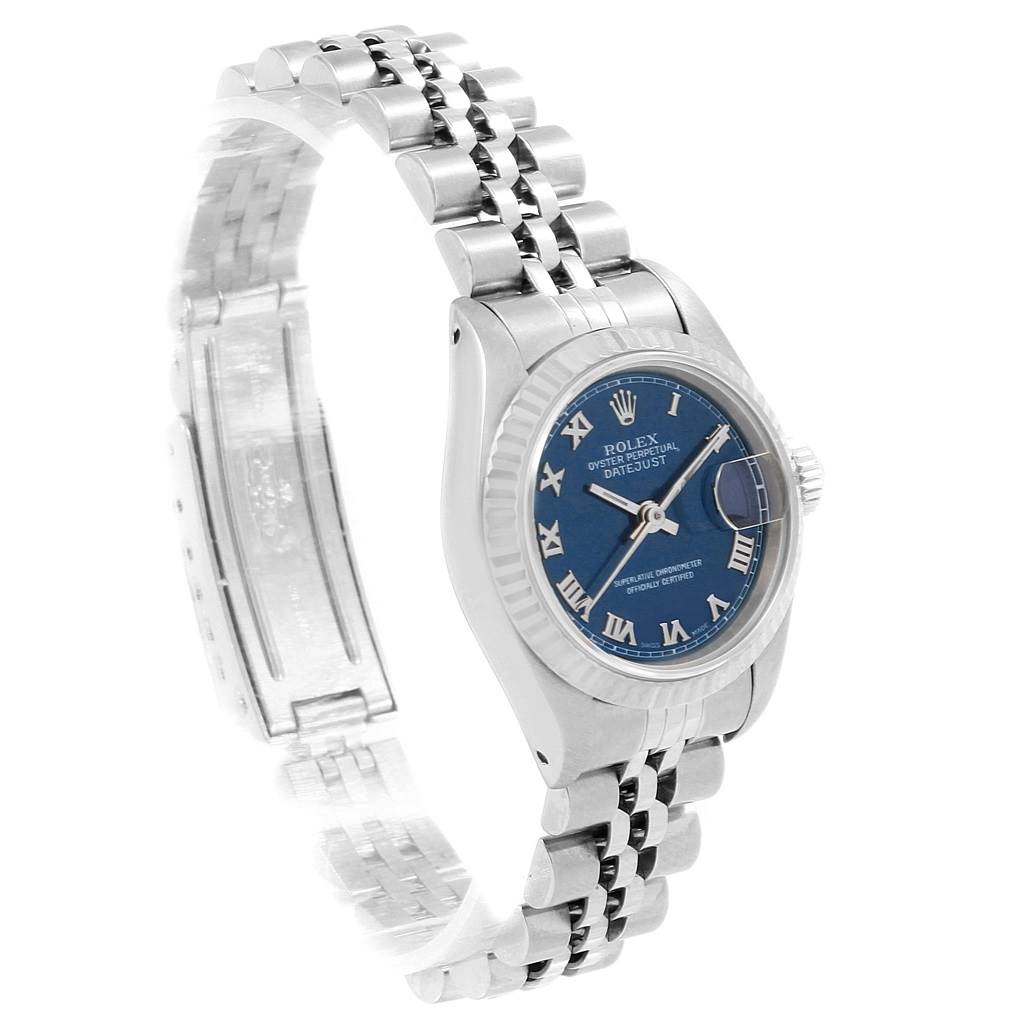 The image shows a side angle of a Rolex Datejust 69174 Women
s Stainless Steel Blue Dial 69174 Women
s Stainless Steel Blue Dial watch, highlighting the blue dial, fluted bezel, and Jubilee bracelet.