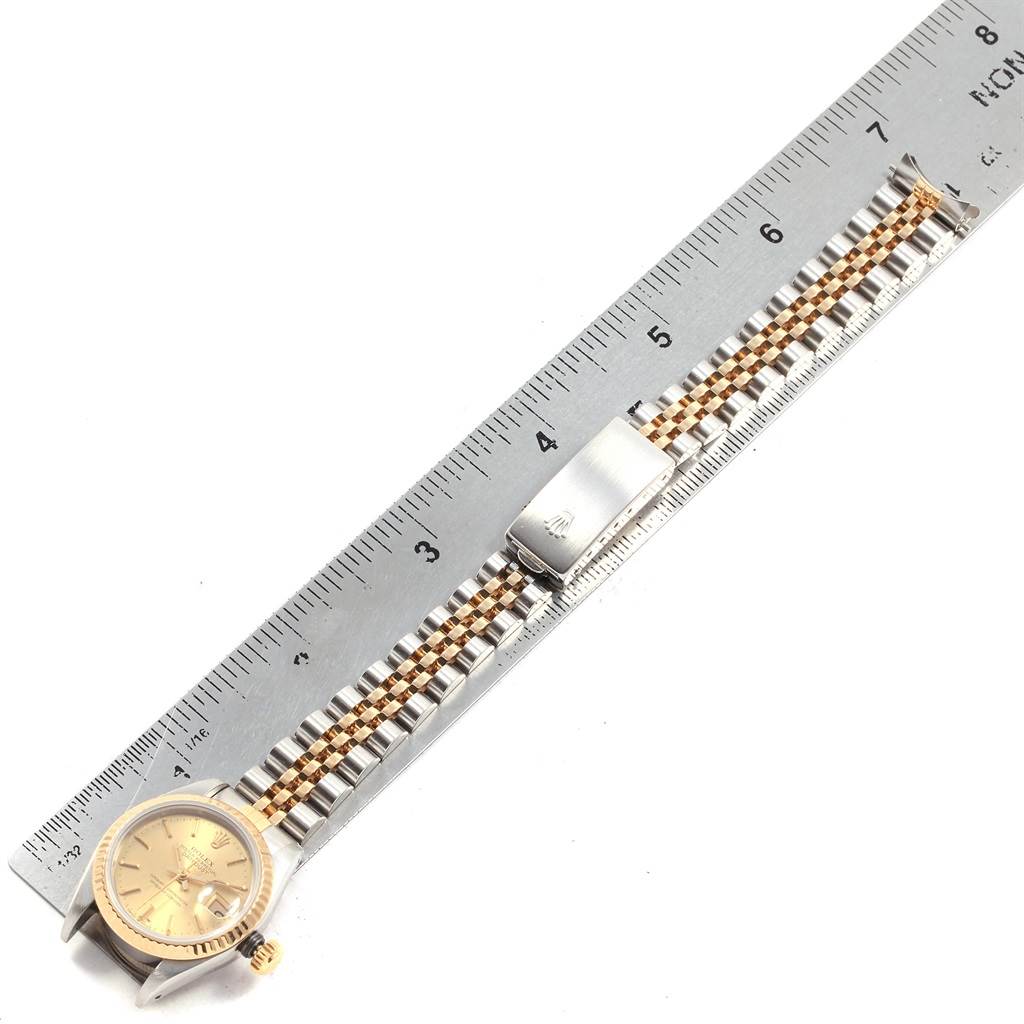 The image shows a Rolex 69173 Men's Stainless Steel Champagne Dial 69173 Men's Stainless Steel Champagne Dial Datejust 26mm Steel 18K Yellow Gold Ladies Watch 69173 laid flat next to a ruler for size reference.