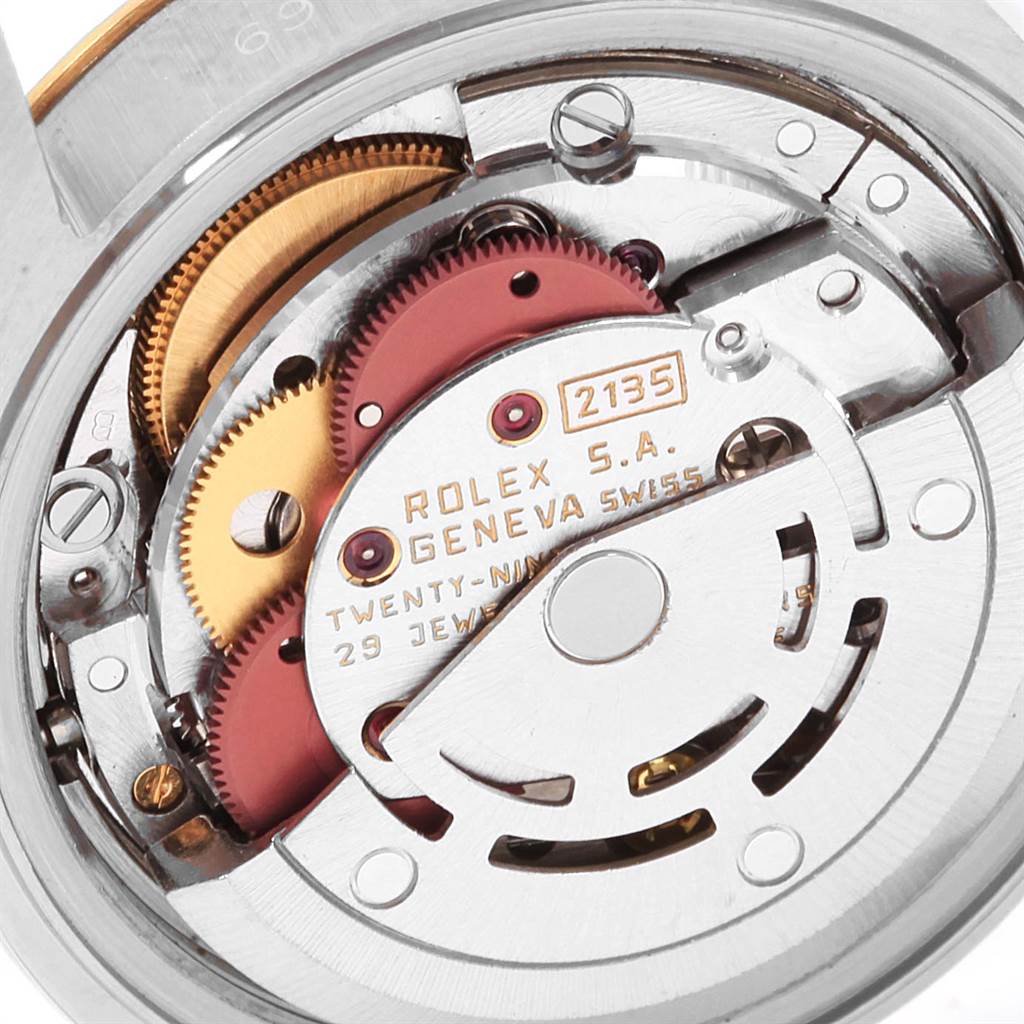This image shows the internal movement parts of a Rolex Datejust 69173 Women's Stainless Steel Champagne Dial 69173 Women's Stainless Steel Champagne Dial watch, including gears and the rotor, from a close-up angle.