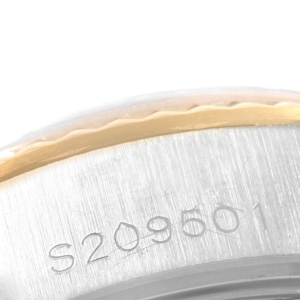 This image shows a close-up of the side of a Rolex Datejust 69173 Women's Stainless Steel Champagne Dial 69173 Women's Stainless Steel Champagne Dial, focusing on the serial number and part of the bezel.