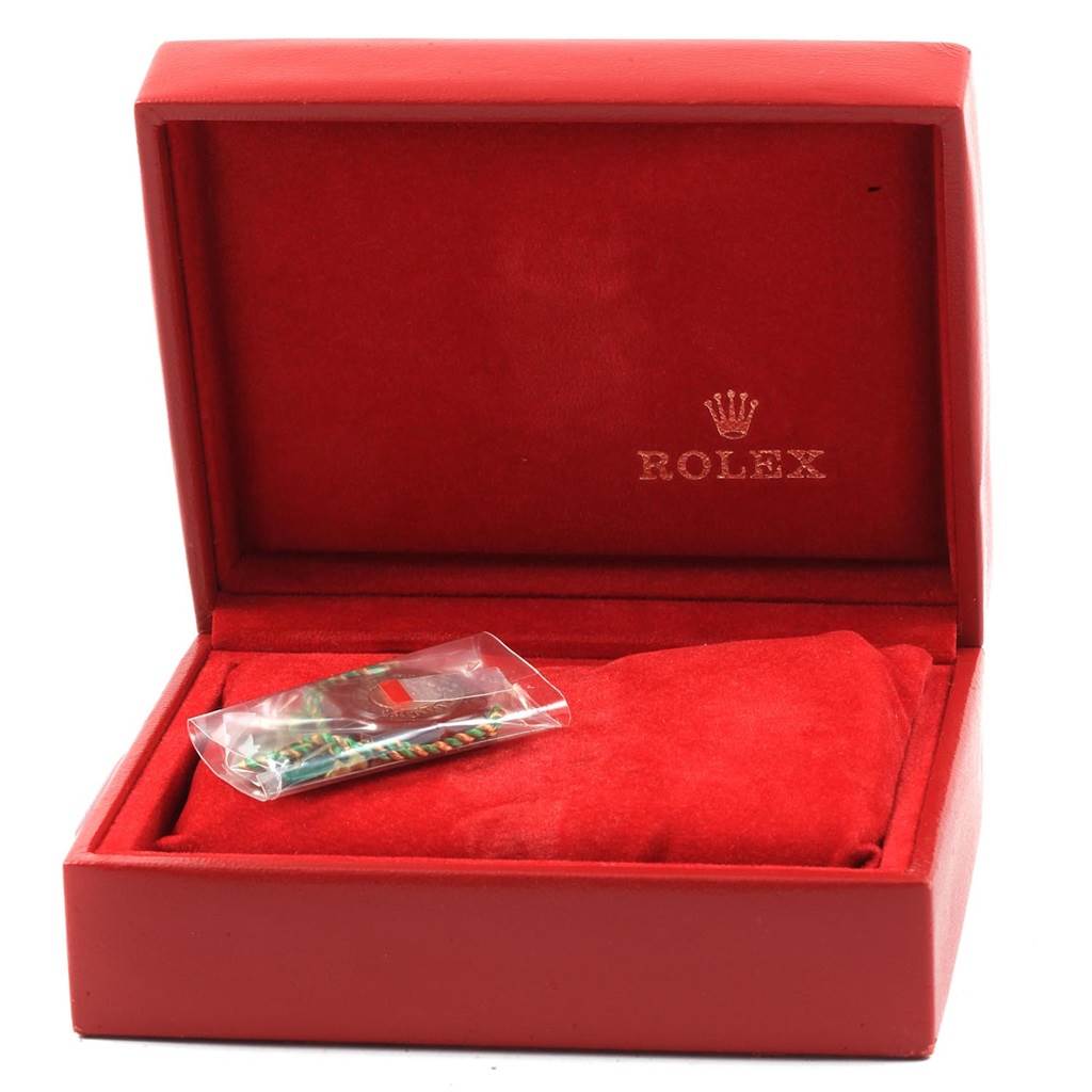 The image shows a Rolex Datejust 69173 Women's Stainless Steel Champagne Dial 69173 Women's Stainless Steel Champagne Dial model watch box with the Rolex logo, containing a wrapped accessory and a red cushion.