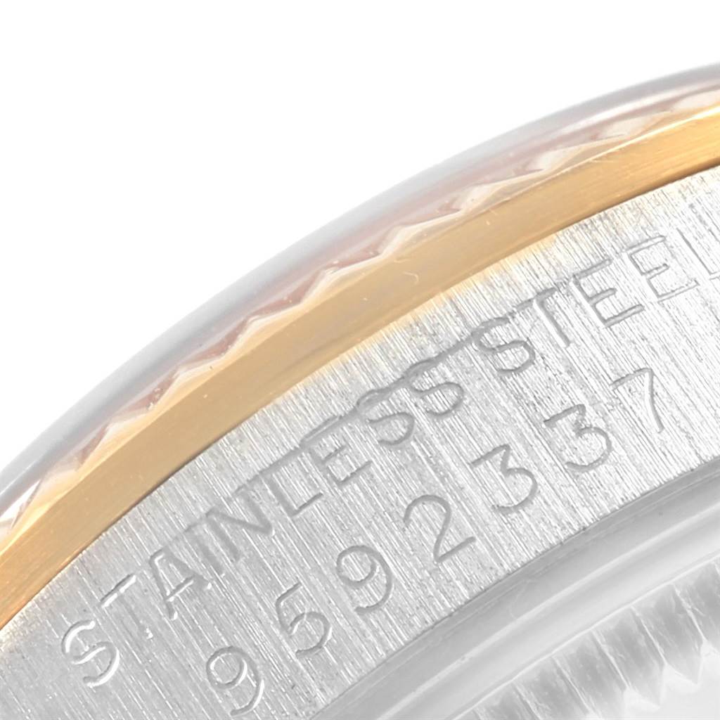 Close-up of the side of a Rolex Datejust 68273 Women's Steel and Gold (two tone) Champagne Dial 68273 Women's Steel and Gold (two tone) Champagne Dial, focusing on the stainless steel and gold bezel with visible inscriptions.
