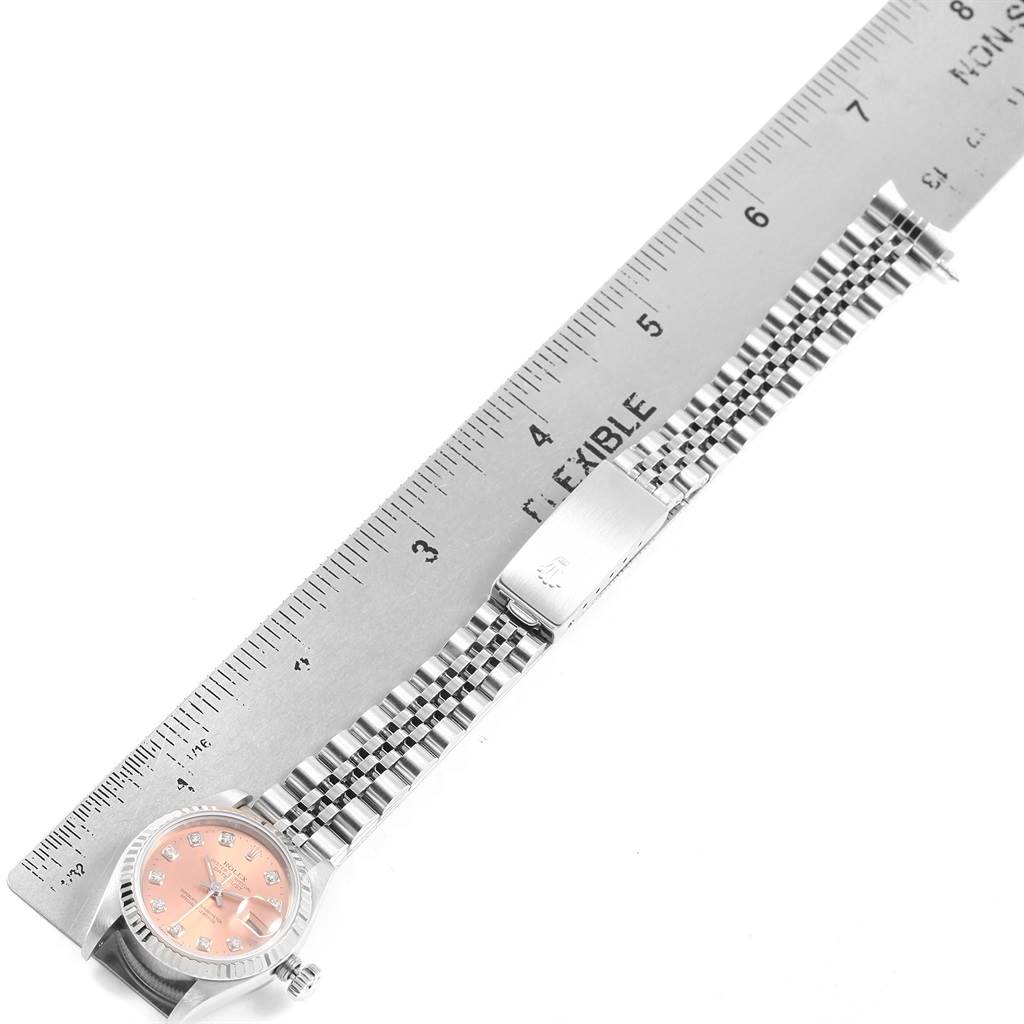 The image shows a top-down view of a Rolex Datejust 69174 Women
s Stainless Steel Pink Dial 69174 Women
s Stainless Steel Pink Dial watch, focusing on the dial, bracelet, and a portion measured with a ruler.