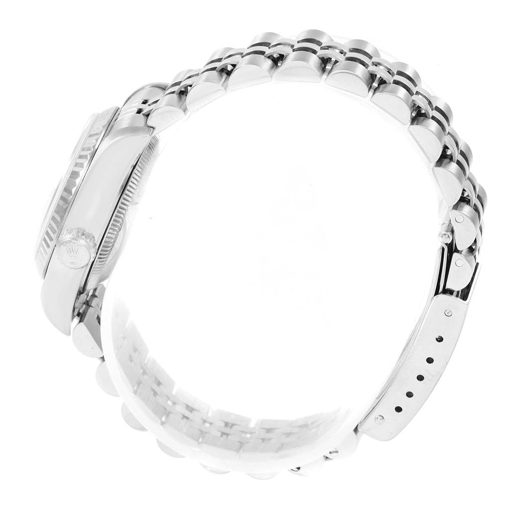 The image shows a side view of a Rolex Datejust 69174 Women
s Stainless Steel Pink Dial 69174 Women
s Stainless Steel Pink Dial watch, highlighting its case and a partial view of its bracelet and clasp.