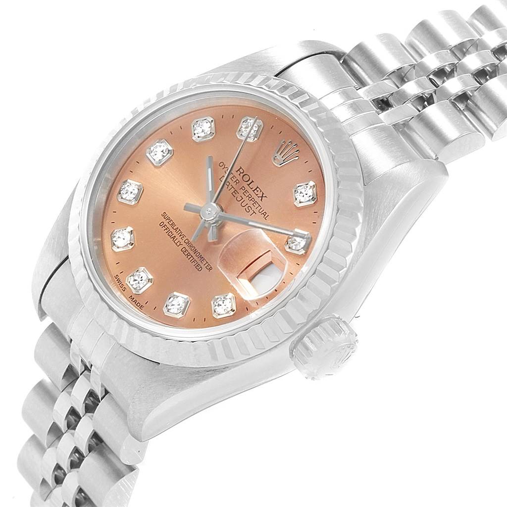 The image shows a close-up angled view of a Rolex Datejust 69174 Women
s Stainless Steel Pink Dial 69174 Women
s Stainless Steel Pink Dial watch featuring its dial, fluted bezel, crown, and bracelet.