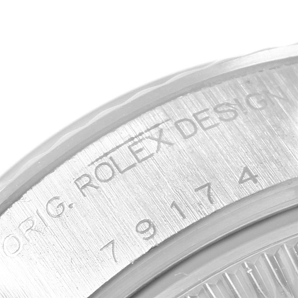 This image shows a close-up of the engraved bezel of a Rolex Datejust 79174 Women's Stainless Steel Black Dial 79174 Women's Stainless Steel Black Dial watch.