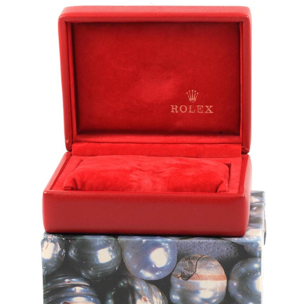This image shows an open Rolex Datejust 79174 Women's Stainless Steel Black Dial 79174 Women's Stainless Steel Black Dial watch box in a red color with the brand name and logo inside.