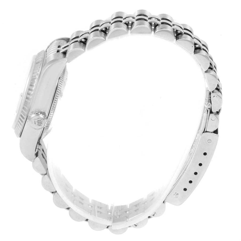 The image shows a side view of a Rolex Datejust 69174 Women
s Stainless Steel Silver Dial 69174 Women
s Stainless Steel Silver Dial watch, highlighting the case, crown, and bracelet.