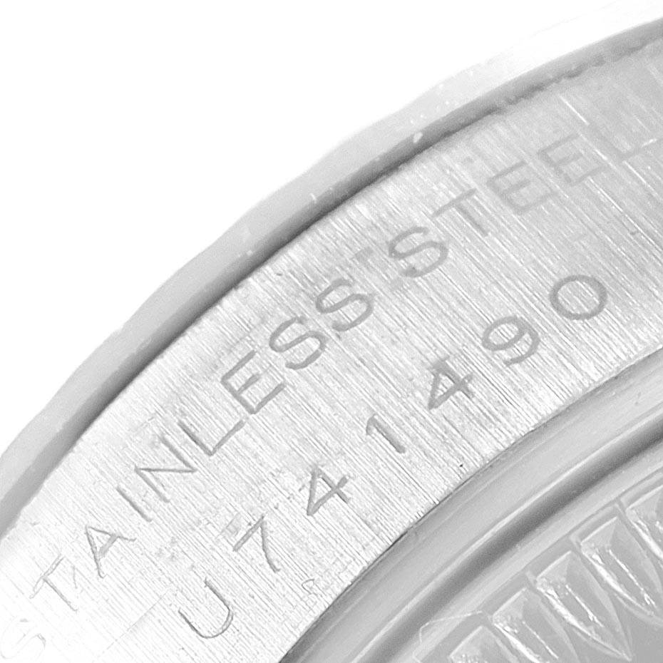 This image shows a close-up of the serial number and "STAINLESS STEEL" engraving on the side of a Rolex Datejust 69174 Women
s Stainless Steel Silver Dial 69174 Women
s Stainless Steel Silver Dial watch.