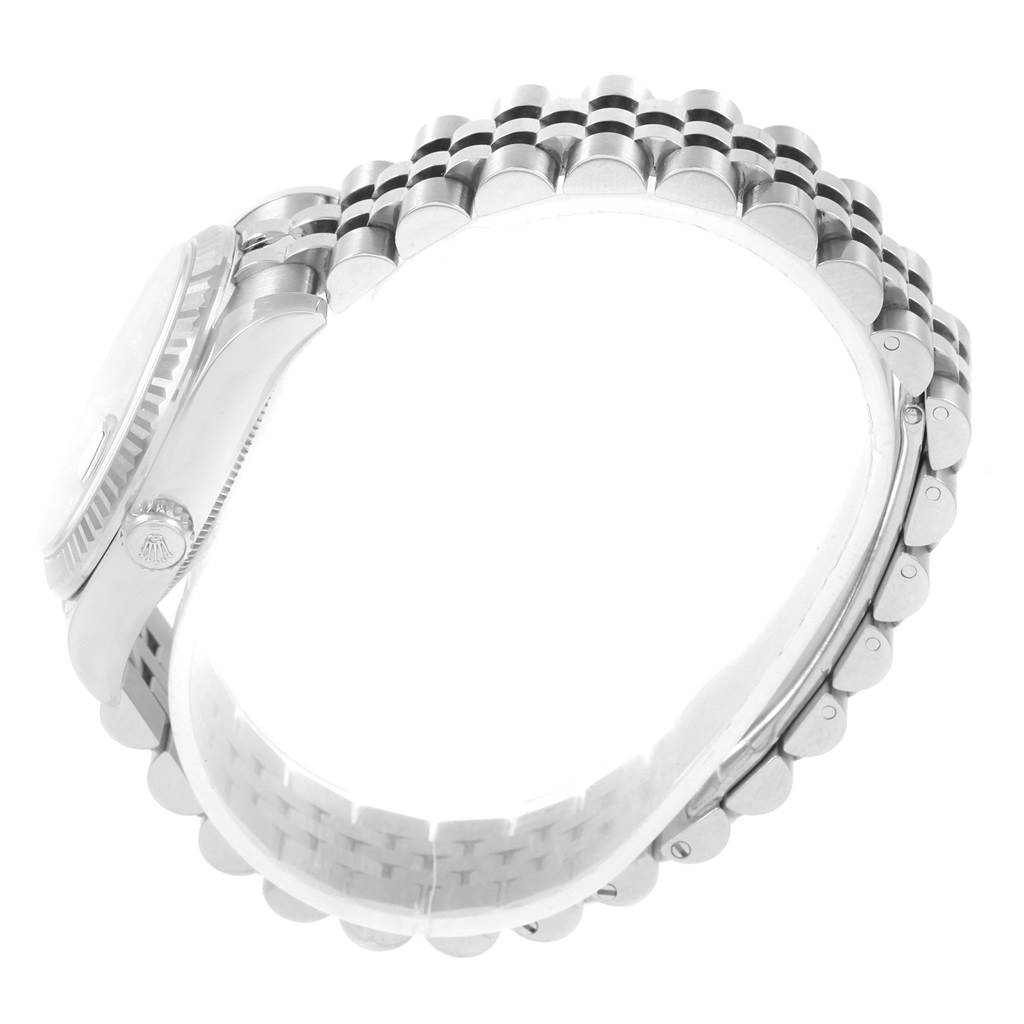 This side-angle view of the Rolex Datejust 178274 Women's Stainless Steel Black Dial 178274 Women's Stainless Steel Black Dial shows the watch case, crown, and a portion of the bracelet.