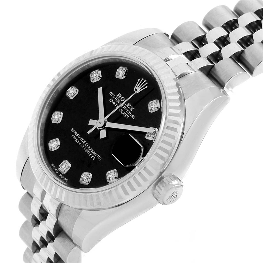 The image shows a Rolex Datejust 178274 Women's Stainless Steel Black Dial 178274 Women's Stainless Steel Black Dial watch from an angle highlighting its face, crown, bezel, and part of its band.