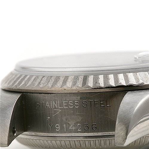 This is a close-up of the side of a Rolex Datejust 79174 Women's Stainless Steel Silver Dial 79174 Women's Stainless Steel Silver Dial watch, showing part of the case, bezel, and serial number engraving.