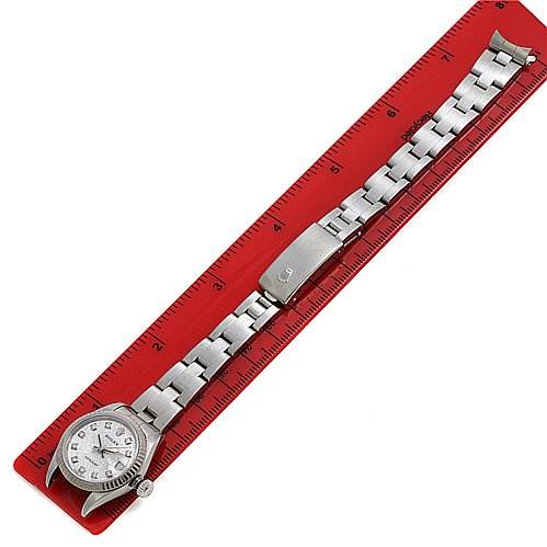 This image shows a Rolex Datejust 79174 Women's Stainless Steel Silver Dial 79174 Women's Stainless Steel Silver Dial watch laid flat on a red ruler, displaying the full dial and bracelet.