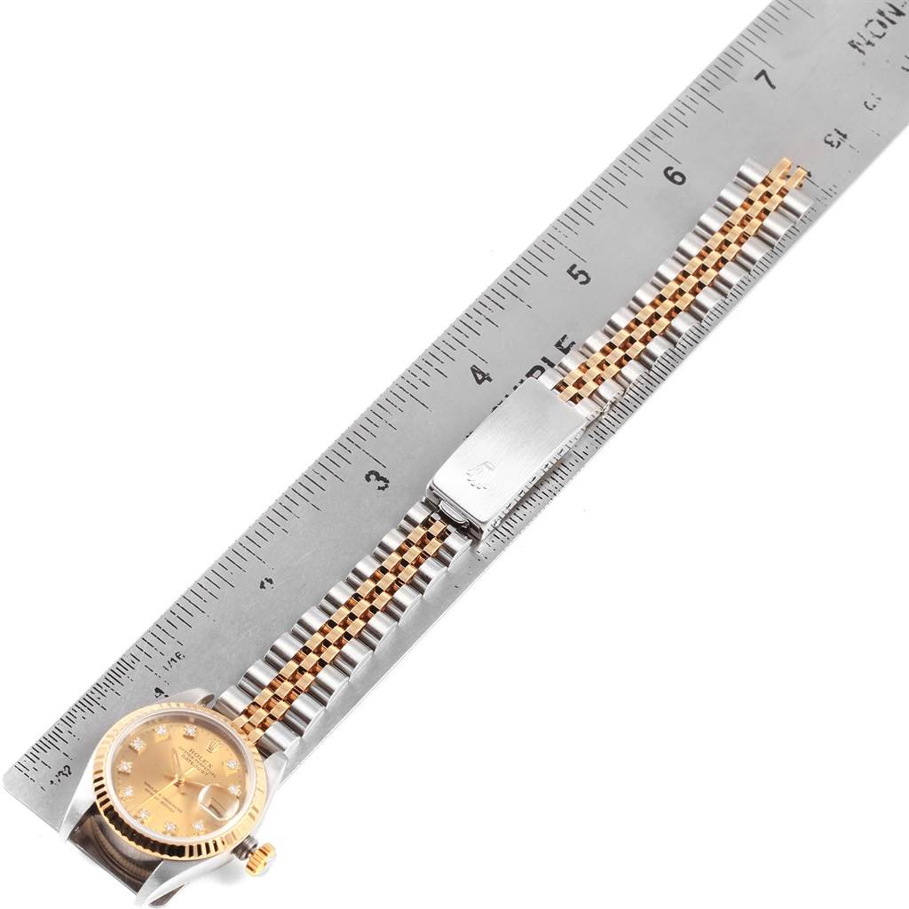 The image shows a top-down view of a Rolex Datejust 69173 Women's Stainless Steel Champagne Dial 69173 Women's Stainless Steel Champagne Dial watch, with the face, bezel, and bracelet visible alongside a ruler for scale.
