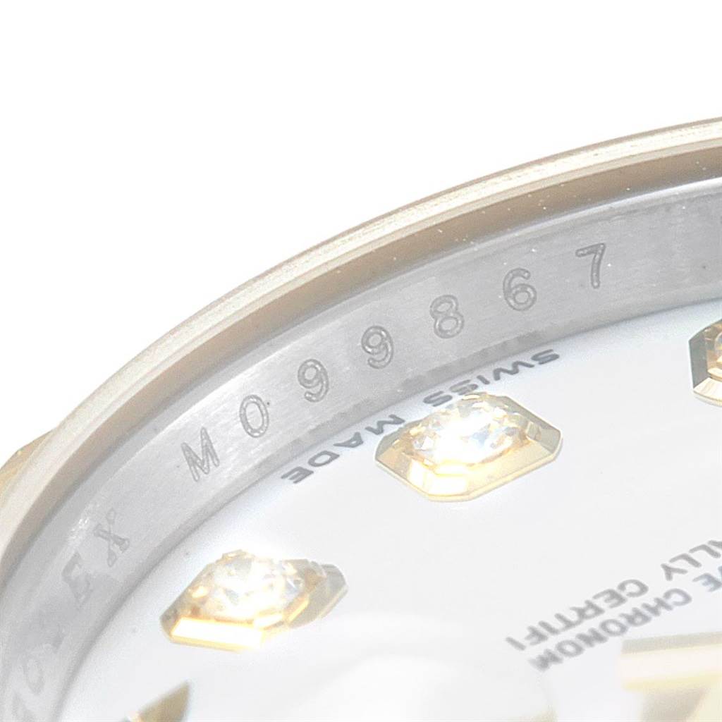 The image shows a close-up of the serial number and part of the dial with diamond indices on a Rolex Datejust 179173 Women's Steel and Gold (two tone) Silver Dial 179173 Women's Steel and Gold (two tone) Silver Dial watch.