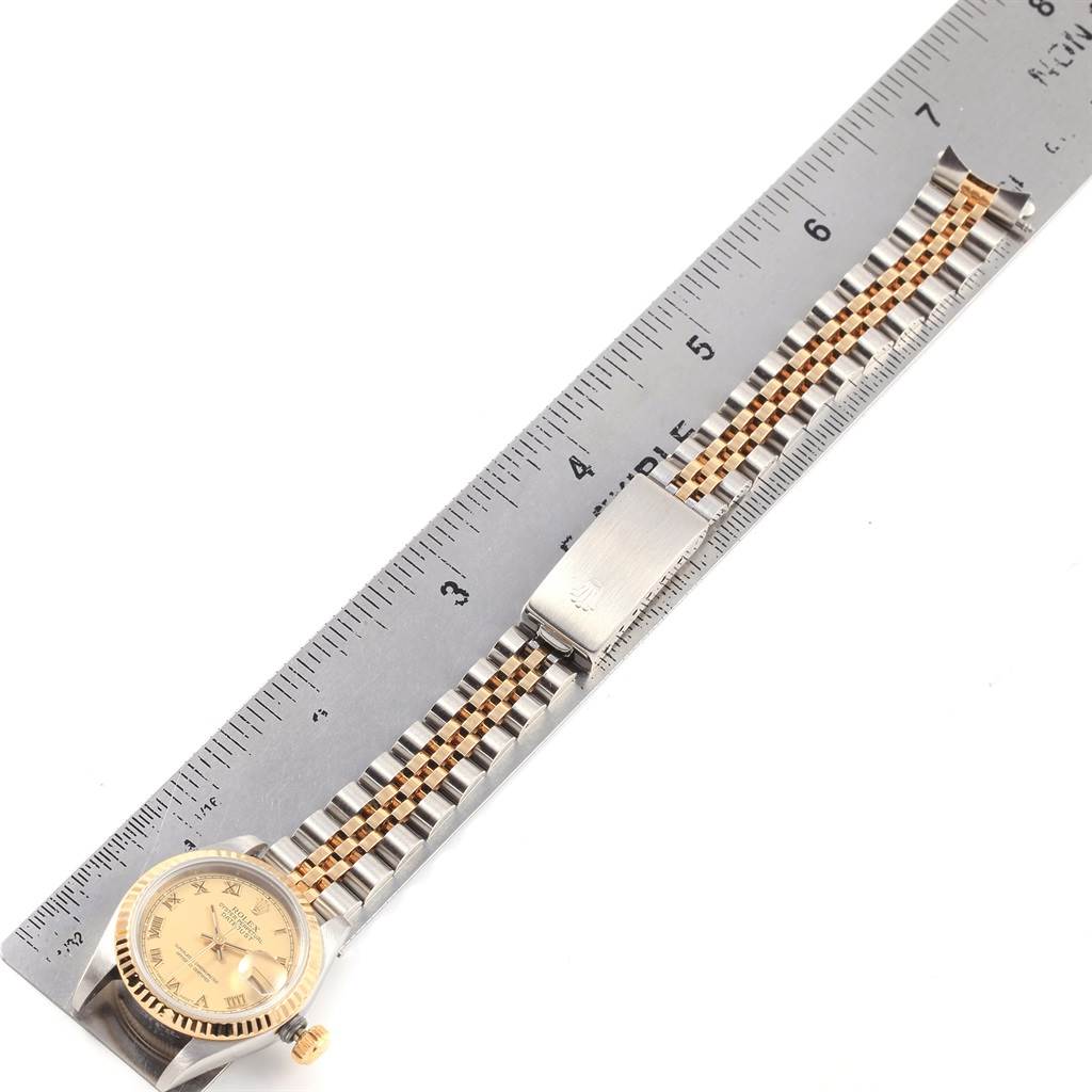 This image shows a Rolex Datejust 69173 Women's Stainless Steel Champagne Dial 69173 Women's Stainless Steel Champagne Dial watch laid flat alongside a ruler, highlighting the dial, case, and two-tone bracelet.