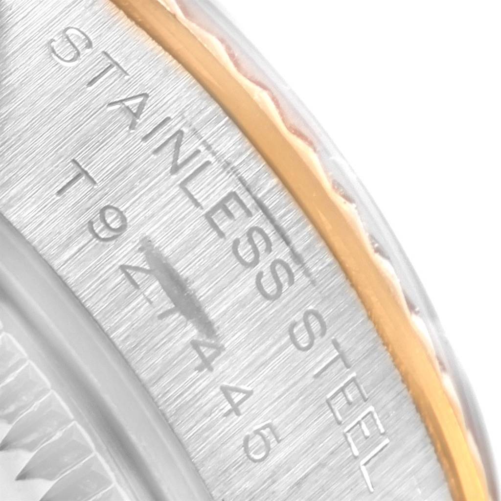 The image shows a close-up angle of the bezel and case edge with engraved text on a Rolex Datejust 69173 Women's Stainless Steel Blue Dial 69173 Women's Stainless Steel Blue Dial watch.