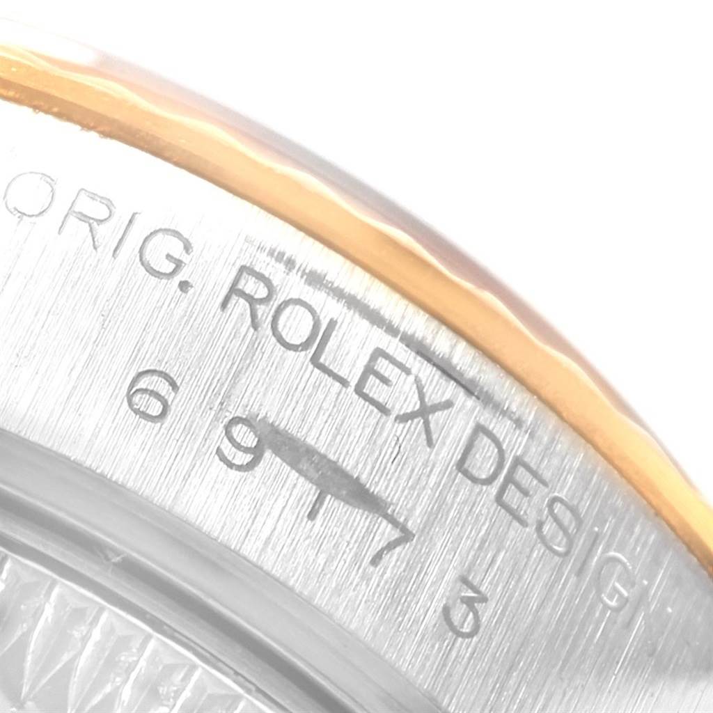 The image shows a close-up of the case back and a part of the bezel of a Rolex Datejust 69173 Women's Stainless Steel Blue Dial 69173 Women's Stainless Steel Blue Dial watch, highlighting engraved text and numbers.