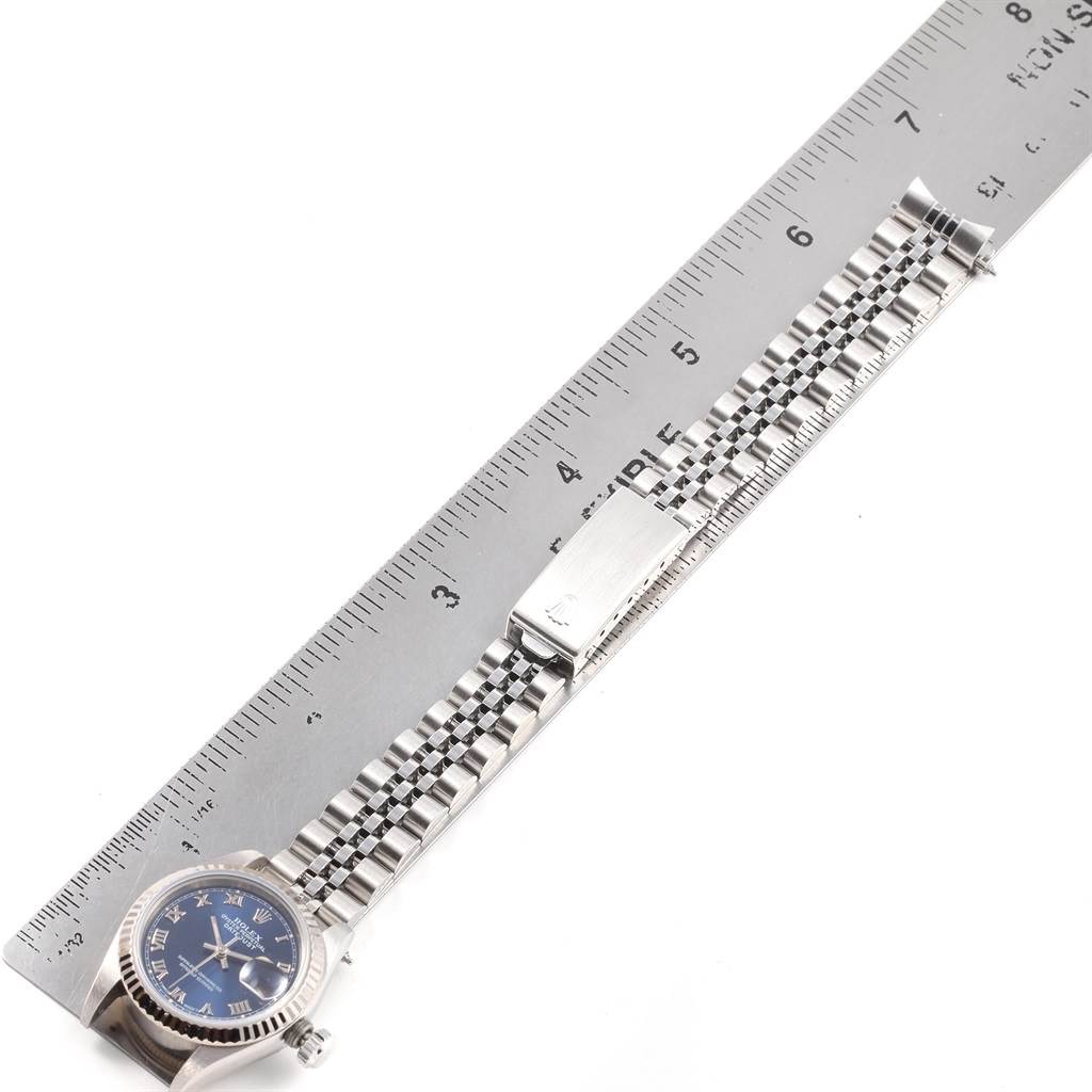 The image shows a Rolex Datejust 69174 Women's Stainless Steel Blue Dial 69174 Women's Stainless Steel Blue Dial watch laid flat alongside a ruler, highlighting the dial and bracelet.