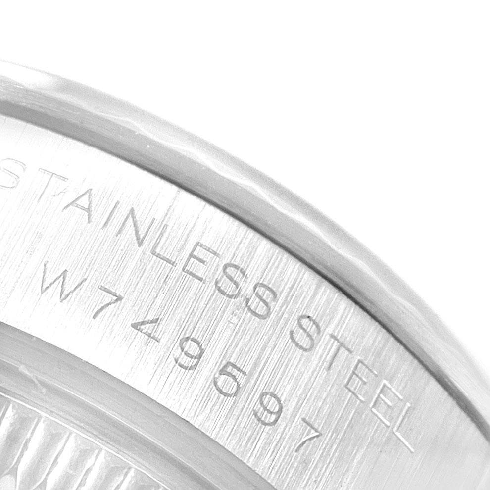 This image shows a close-up view of the serial number engraving on the stainless steel casing of a Rolex Datejust 69174 Women's Stainless Steel Blue Dial 69174 Women's Stainless Steel Blue Dial watch.
