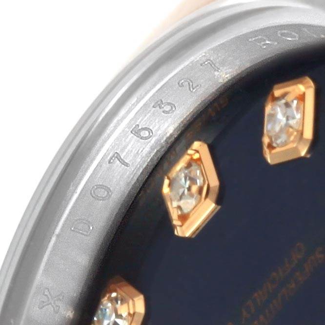 The image shows a close-up of the Rolex Datejust 179161 Women's Steel and Gold (two tone) Blue Dial 179161 Women's Steel and Gold (two tone) Blue Dial watch bezel with diamond hour markers and part of the serial number.