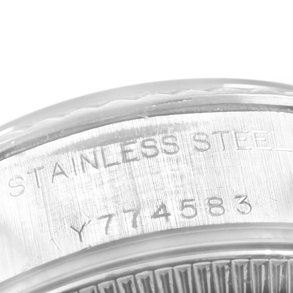 This image shows a close-up of the stainless steel case back of a Rolex Datejust 79174 Women
s Stainless Steel Blue Dial 79174 Women
s Stainless Steel Blue Dial watch with a partial view of its serial number.