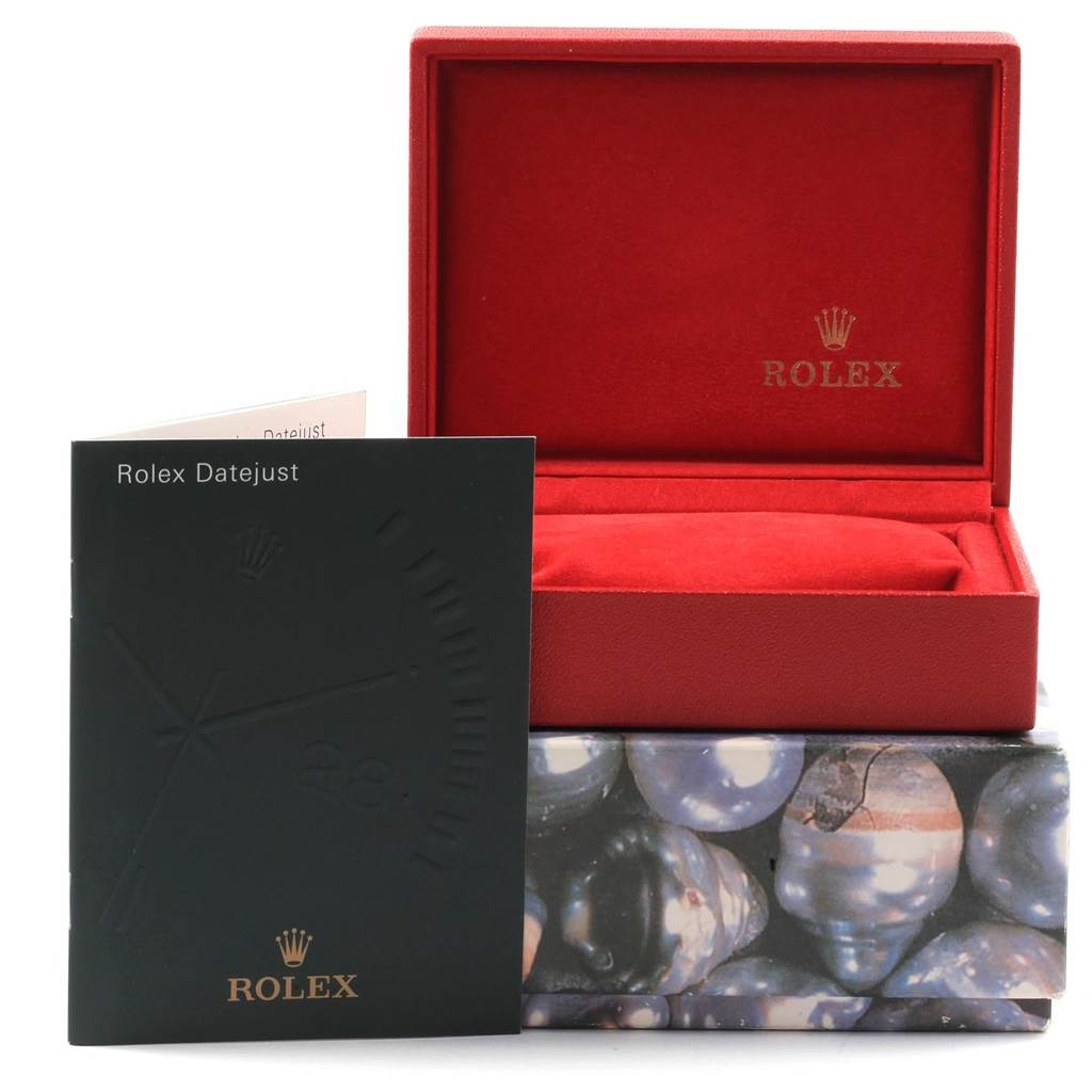 The image showcases a Rolex Datejust 79174 Women
s Stainless Steel Blue Dial 79174 Women
s Stainless Steel Blue Dial manual, an empty red Rolex watch box, and a patterned outer box viewed from the front.