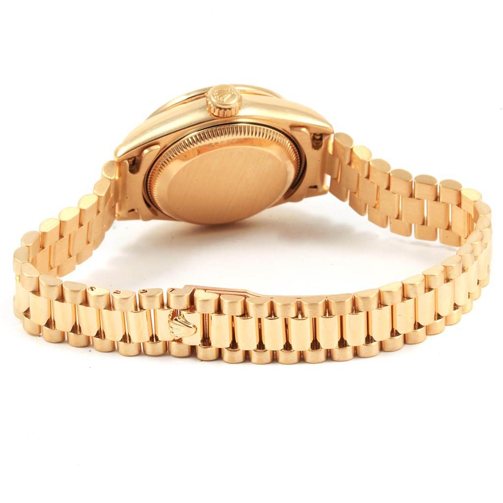 The image shows the back view of a Rolex Datejust 79138 Women's Yellow Gold Black Dial 79138 Women's Yellow Gold Black Dial watch showcasing its case back and bracelet.