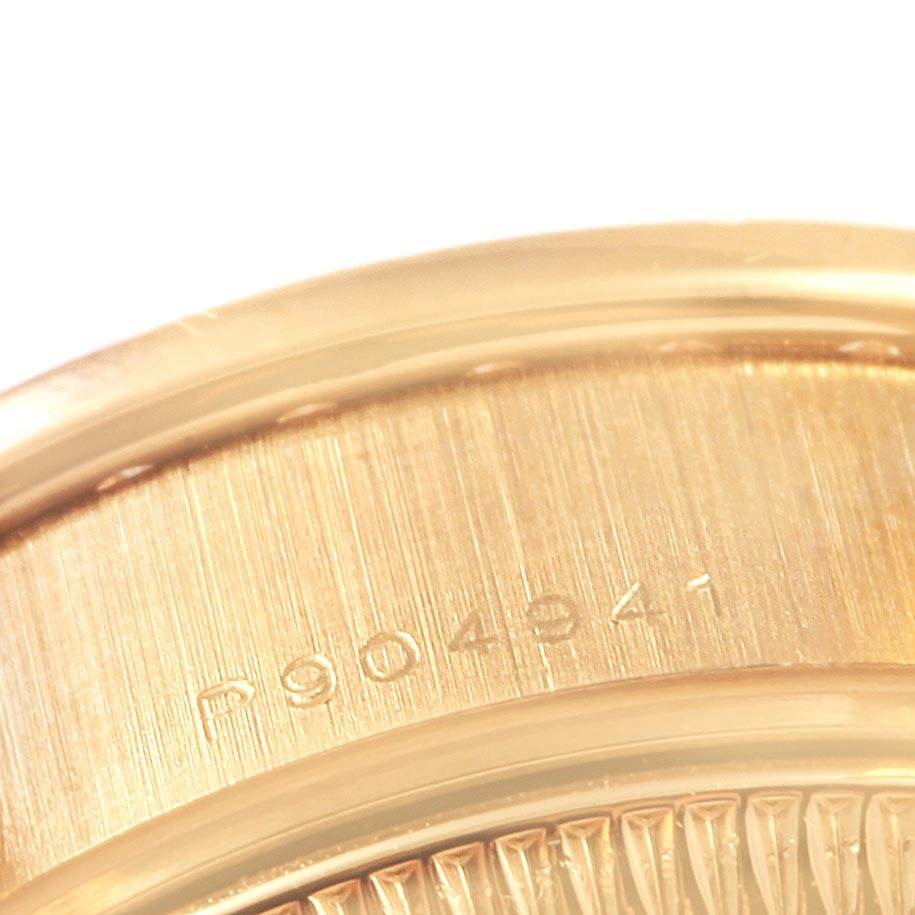 The image shows a close-up of the case back and part of the case edge of a Rolex Datejust 79138 Women's Yellow Gold Black Dial 79138 Women's Yellow Gold Black Dial watch with a visible serial number.