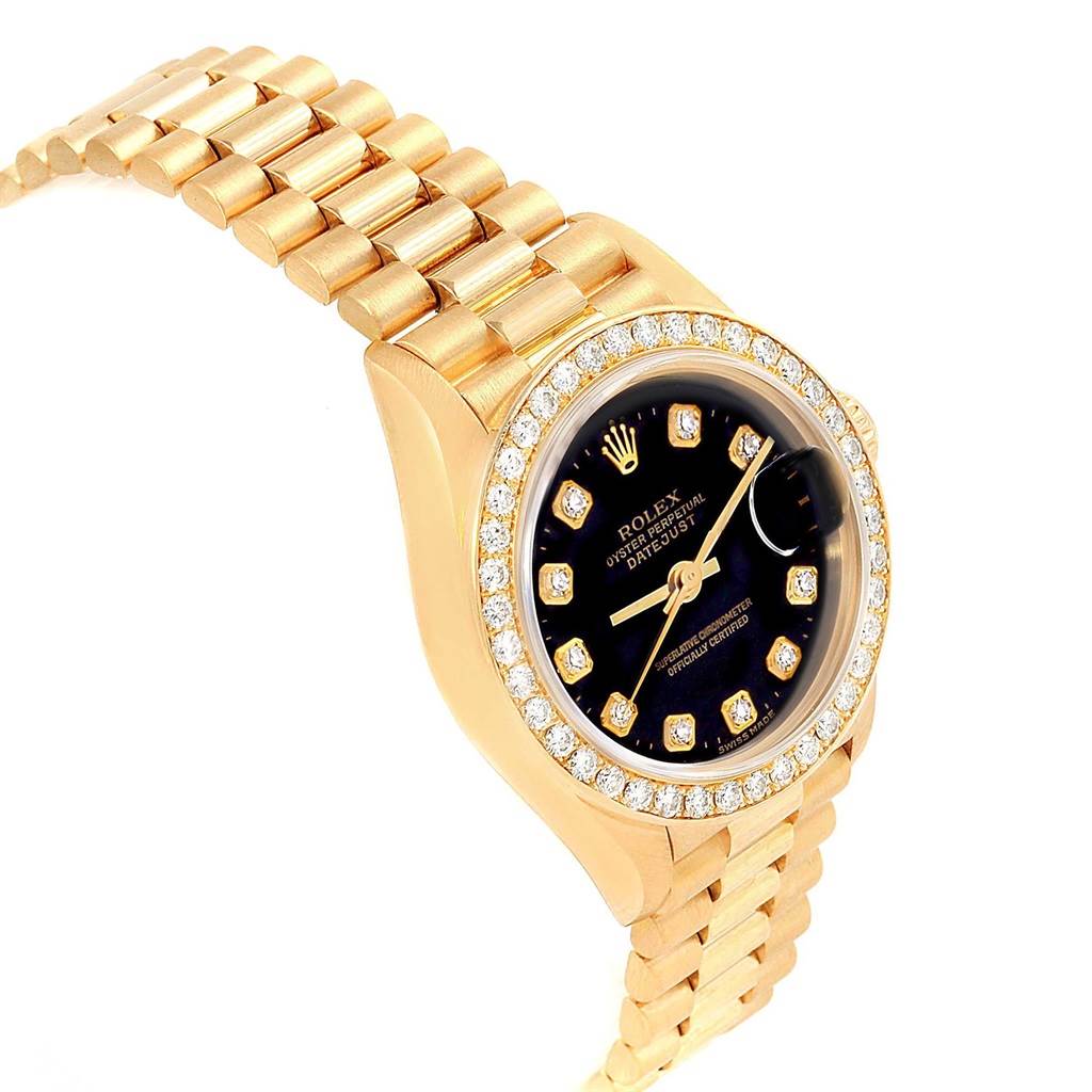 The image shows the Rolex Datejust 79138 Women's Yellow Gold Black Dial 79138 Women's Yellow Gold Black Dial watch angled from the left side, featuring its gold bracelet, diamond bezel, and black dial.