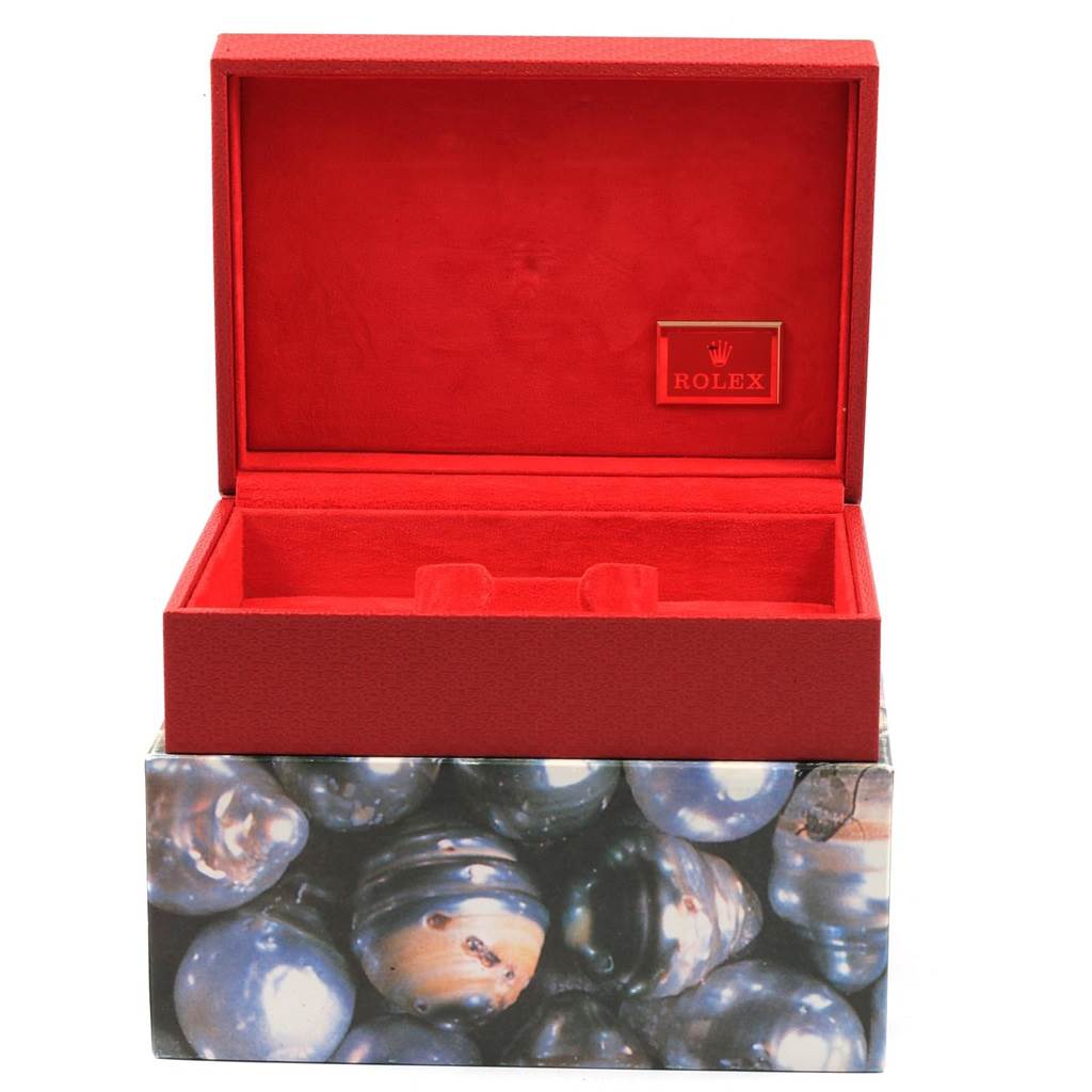 The image shows an open red Rolex Datejust 79138 Women's Yellow Gold Black Dial 79138 Women's Yellow Gold Black Dial watch box with an additional outer decorative cover featuring a pearl-like design.