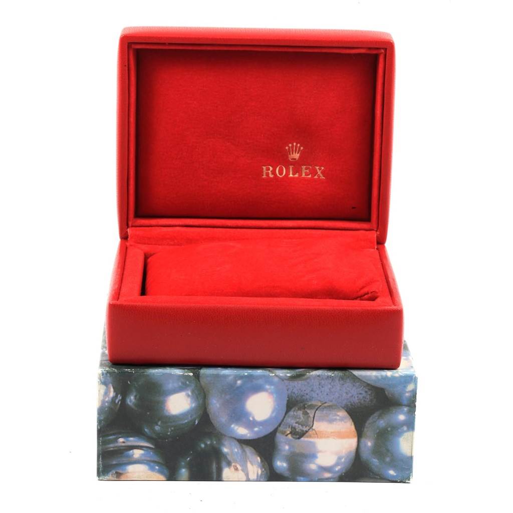 The image shows an open red Rolex Datejust 79174 Women's Stainless Steel Black Dial 79174 Women's Stainless Steel Black Dial watch box, devoid of the watch.