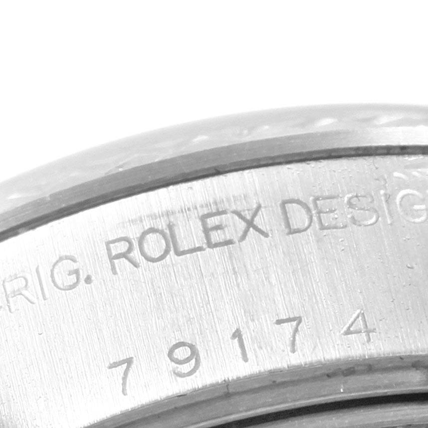 The image shows a close-up of the engraved inner rim of a Rolex Datejust 79174 Women's Stainless Steel Black Dial 79174 Women's Stainless Steel Black Dial watch case.