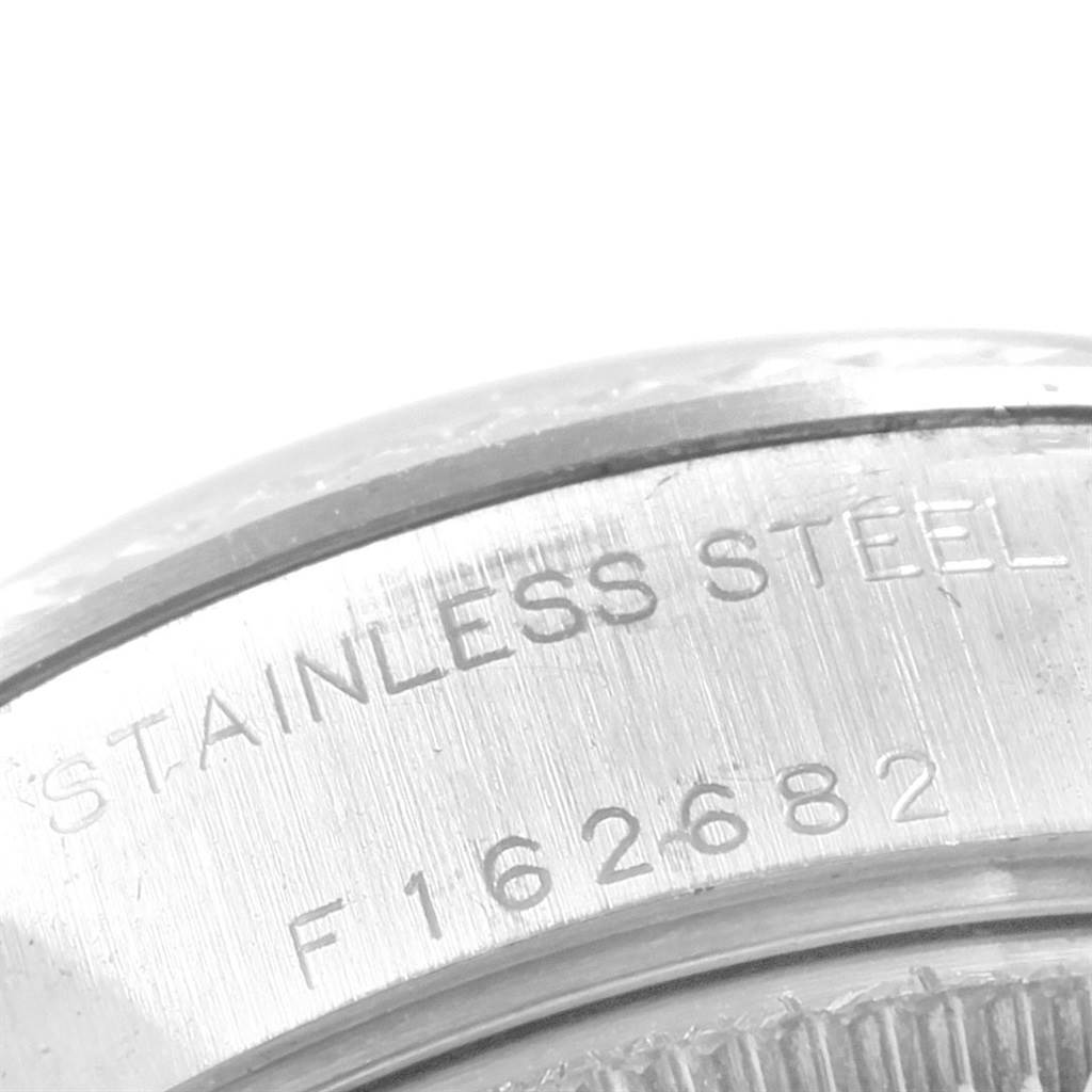 This image shows a close-up view of the stainless steel caseback of a Rolex Datejust 79174 Women's Stainless Steel Black Dial 79174 Women's Stainless Steel Black Dial model, highlighting the material and serial number.