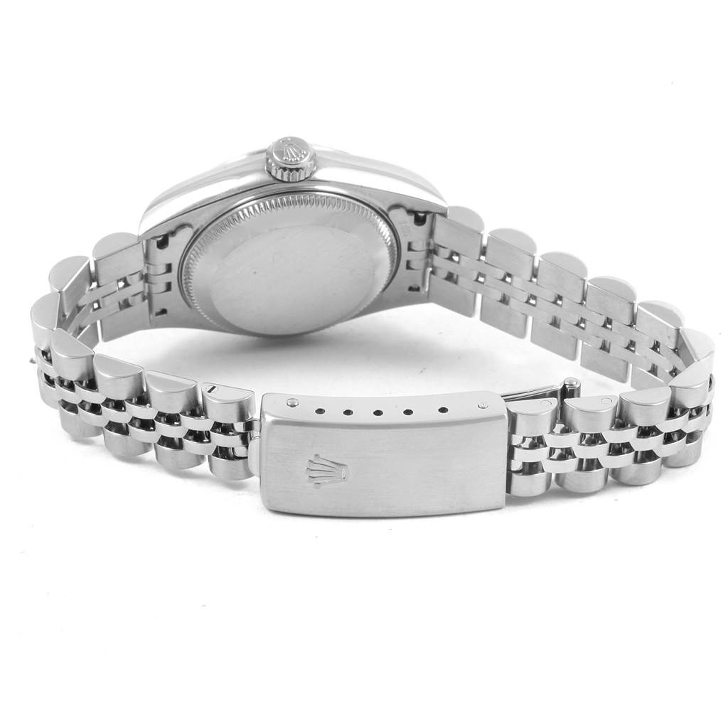 The image shows the back view of a Rolex Datejust 79174 Women's Stainless Steel Pink Dial 79174 Women's Stainless Steel Pink Dial watch, highlighting its case back and partially open metal bracelet.