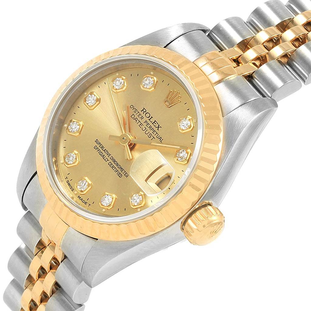 This is an angled view of the face, crown, bezel, dial, and partially the two-tone bracelet of a Rolex Datejust 69173 Women
s Stainless Steel Champagne Dial 69173 Women
s Stainless Steel Champagne Dial watch.
