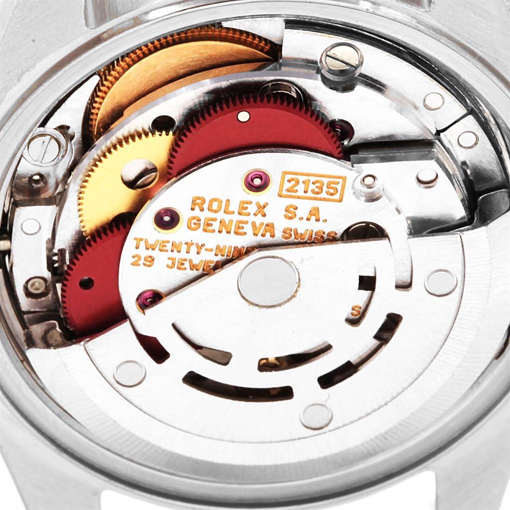 The image shows a close-up of the movement mechanism of a Rolex Datejust 69173 Women
s Stainless Steel Champagne Dial 69173 Women
s Stainless Steel Champagne Dial watch, highlighting internal gears and components.