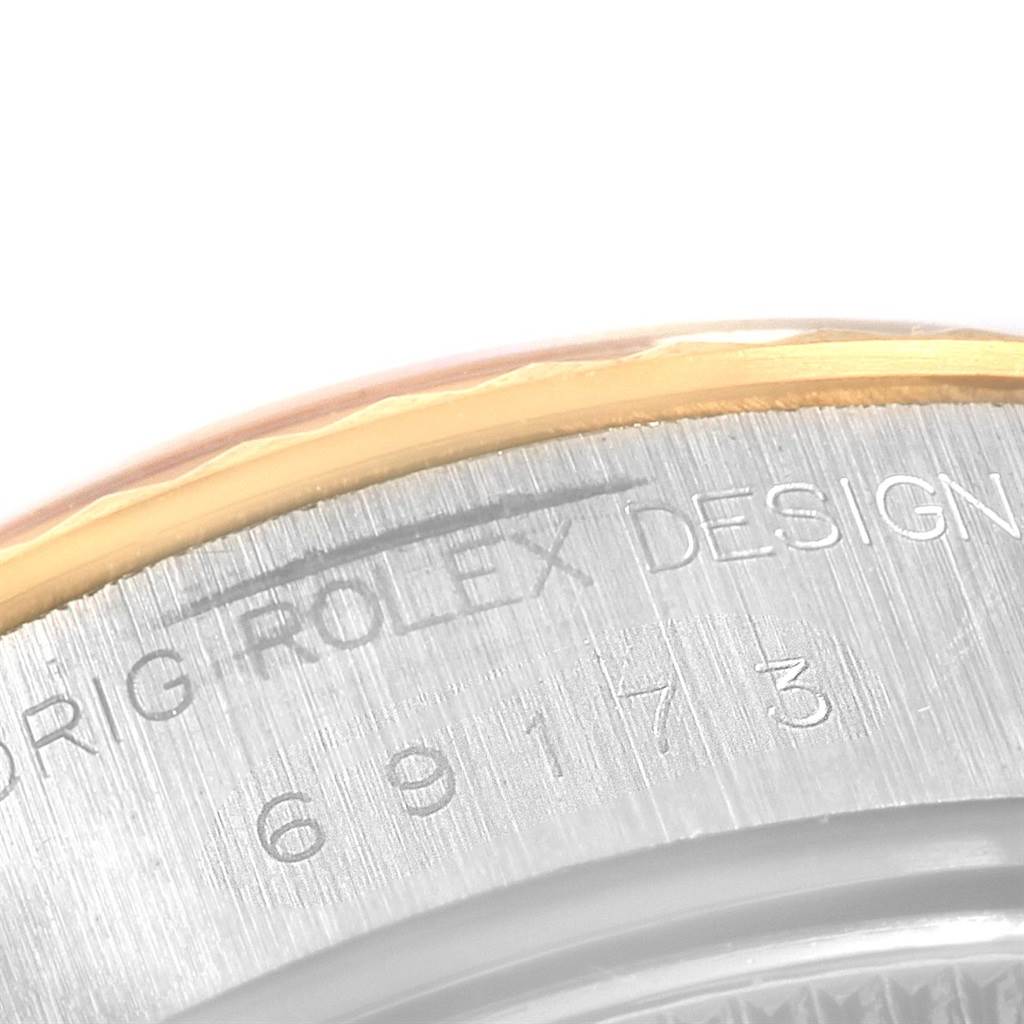 The image shows a close-up of the case back of a Rolex Datejust 69173 Women
s Stainless Steel Champagne Dial 69173 Women
s Stainless Steel Champagne Dial watch, highlighting the engraving.