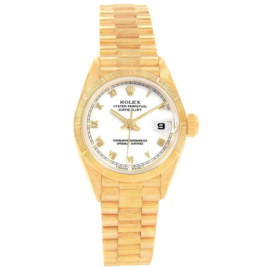 The Rolex Datejust 69278 Women's Yellow Gold White Dial 69278 Women's Yellow Gold White Dial watch is displayed from a top-down angle, showing its face, bracelet, and crown.