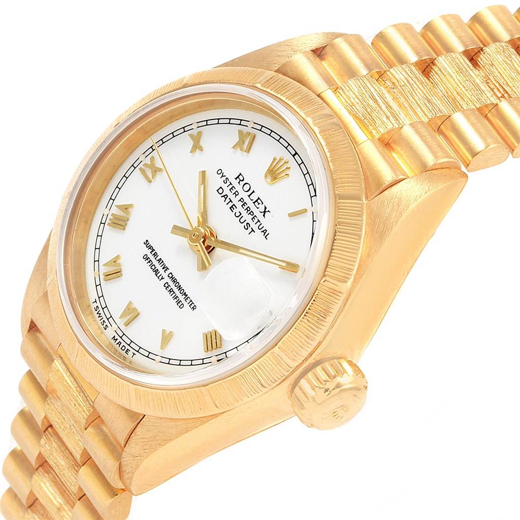 The image shows a partial side view of a Rolex Datejust 69278 Women's Yellow Gold White Dial 69278 Women's Yellow Gold White Dial watch, highlighting the crown, bezel, dial, and part of the bracelet.