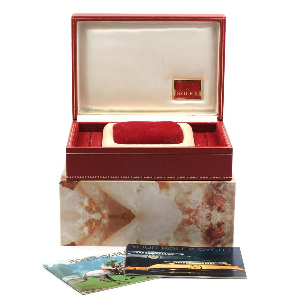 This image shows the packaging and accessories for a Rolex Datejust 69278 Women's Yellow Gold White Dial 69278 Women's Yellow Gold White Dial watch, including a red watch box and booklets.