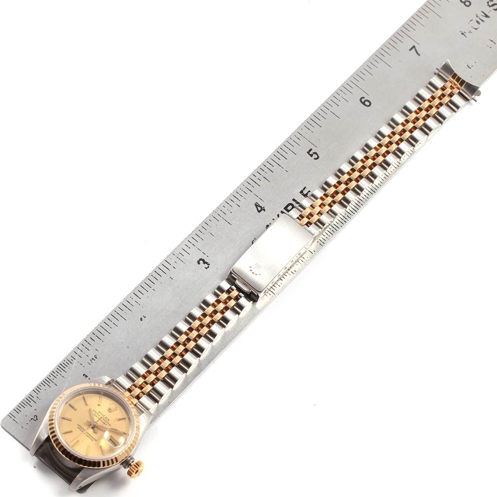 The image shows the Rolex Datejust 69173 Women's Stainless Steel Champagne Dial 69173 Women's Stainless Steel Champagne Dial watch laid flat with a tape measure, displaying the side and bracelet in detail.