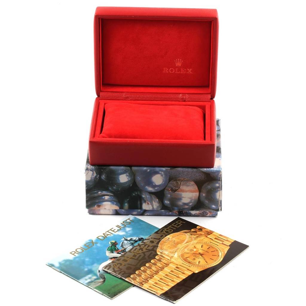 The image shows a red Rolex watch box for the Datejust model, along with related booklets placed in front of the box.