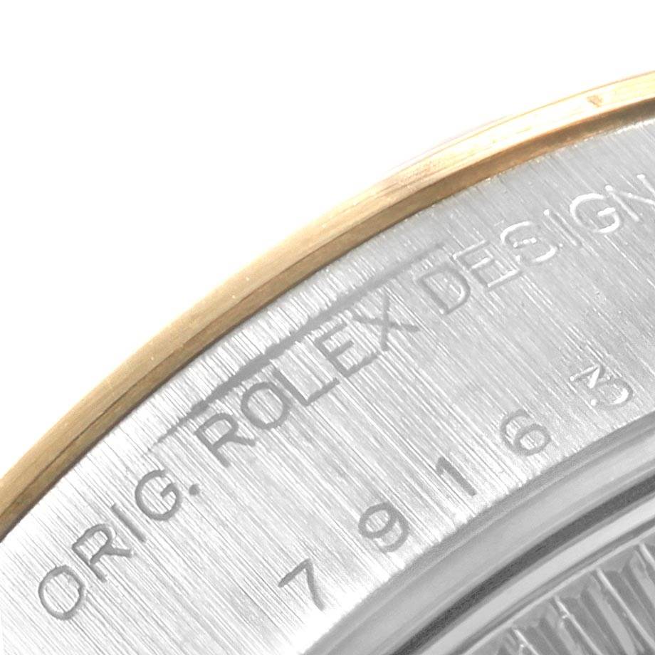 Close-up view of the case back edge of a Rolex Datejust 79163 Women's Steel and Gold (two tone) White Dial 79163 Women's Steel and Gold (two tone) White Dial watch, showing part of the model number and "ROLEX DESIGN" engraving.