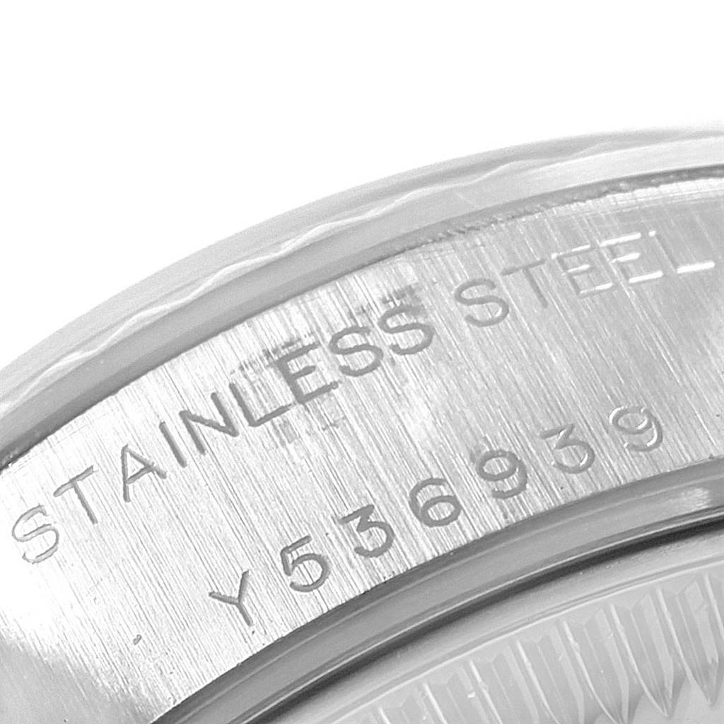 This is a close-up of the serial number and "STAINLESS STEEL" engraving on the side of a Rolex Datejust 79174 Women
s Stainless Steel Black Dial 79174 Women
s Stainless Steel Black Dial watch case.